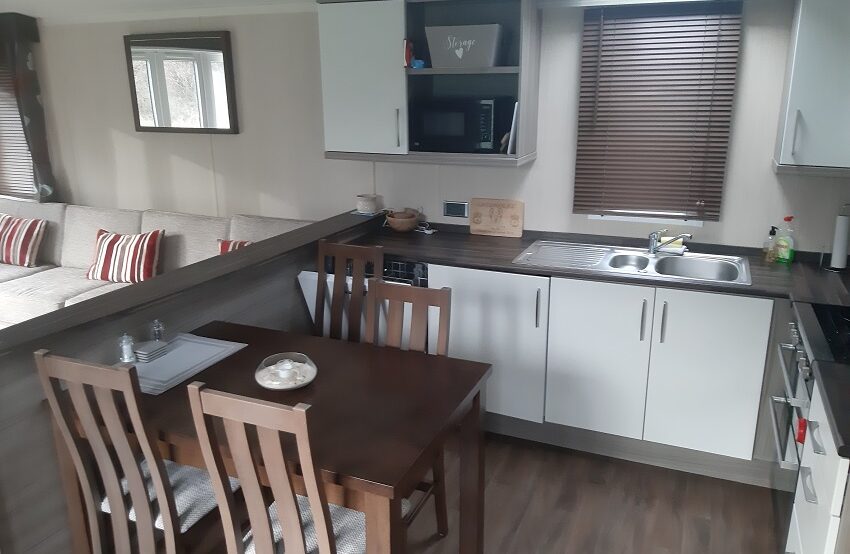 massive/modern kitchen with lots of storage and a free standing dining table and chairs