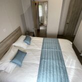Mester bedroom incorporating the full width of the lodge - walk through wardrobe and en-suite shower room